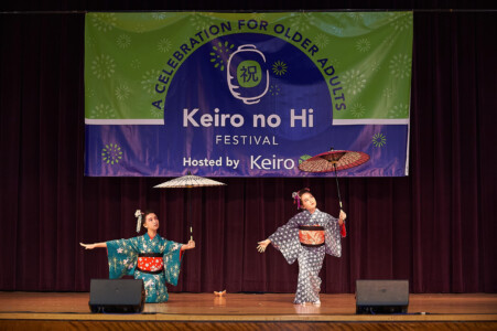 M PALMA PHOTO 2025 two young Japanese dancers on stage holding umbrellas