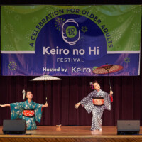 M PALMA PHOTO 2025 two young Japanese dancers on stage holding umbrellas