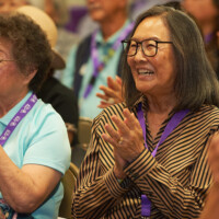 M PALMA PHOTO 2025 woman smiling and clapping in crowd