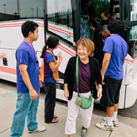 M PALMA PHOTO 2025 woman walking off of bus smiling