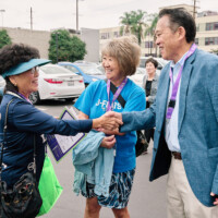 M PALMA PHOTO 2025 three people, two of them shaking hands