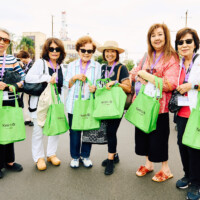 M PALMA PHOTO 2025 six women holding green Keiro gift bags