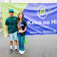 M PALMA PHOTO 2025 man and woman posing in front of Keiro no Hi Festival sign