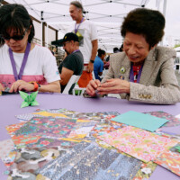 M PALMA PHOTO 2025 two woman making origami