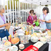 M PALMA PHOTO 2025 two women at ceramics vendor booth