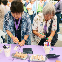 M PALMA PHOTO 2025 two women stamping bookmarks