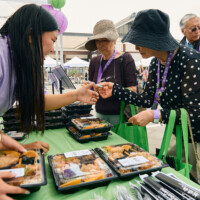 M PALMA PHOTO 2025 woman giving ticket to volunteer to receive bento