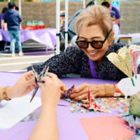 M PALMA PHOTO 2025 woman smiling making origami