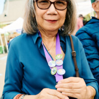 M PALMA PHOTO 2025 woman in blue shirt showing five buttons on lanyard