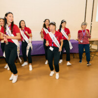 M PALMA PHOTO 2025 Nisei Week court wearing red shirts dancing