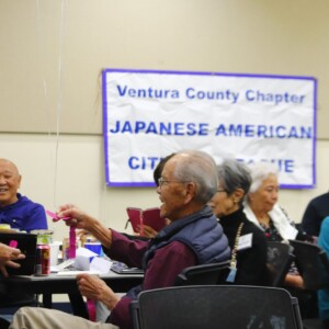 attendees placing raffle tickets in box