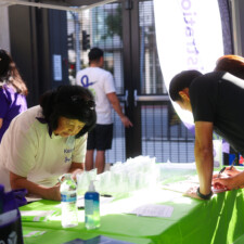 people writing on green table