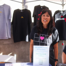 woman in black shirt with shirts in the background
