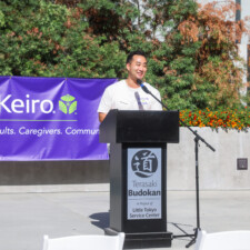 a man talking on a black podium
