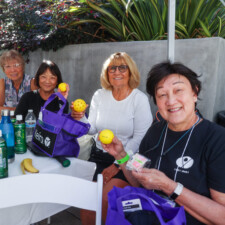 group of women holding onto yellow balls