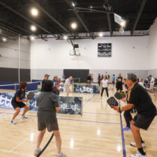 group of people playing pickleball