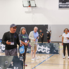 a man in a black shirt instructing a class