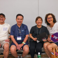 a group of people smiling with paddles