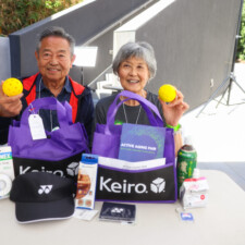 a man and woman holding a yellow ball