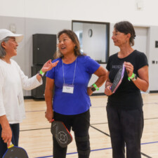 three woman talking with paddles