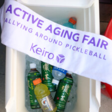 white towel with purple text over a cooler