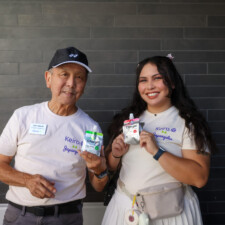 a man and a woman holding a pouch