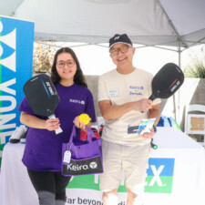 a man and a woman holding a paddle