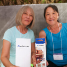 two women holding a white box