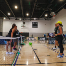 a group of people talking over a net