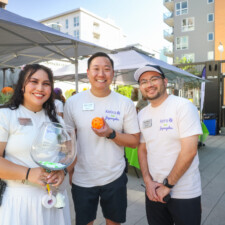a woman holding a bowl, a man holding a purple ball, and a man smiling