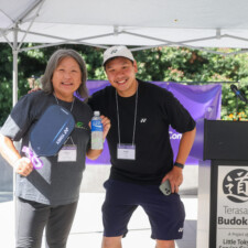 a man in black and a woman in gray smiling