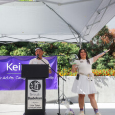 a woman posing with a man by a podium