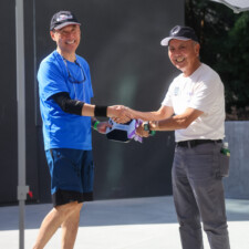 a man giving a man in blue a paddle