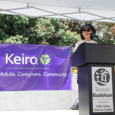 a woman in a visor talking behind a podium