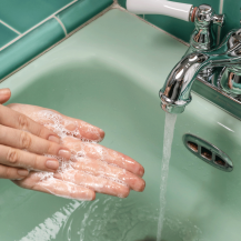 hand washing at the sink with soap