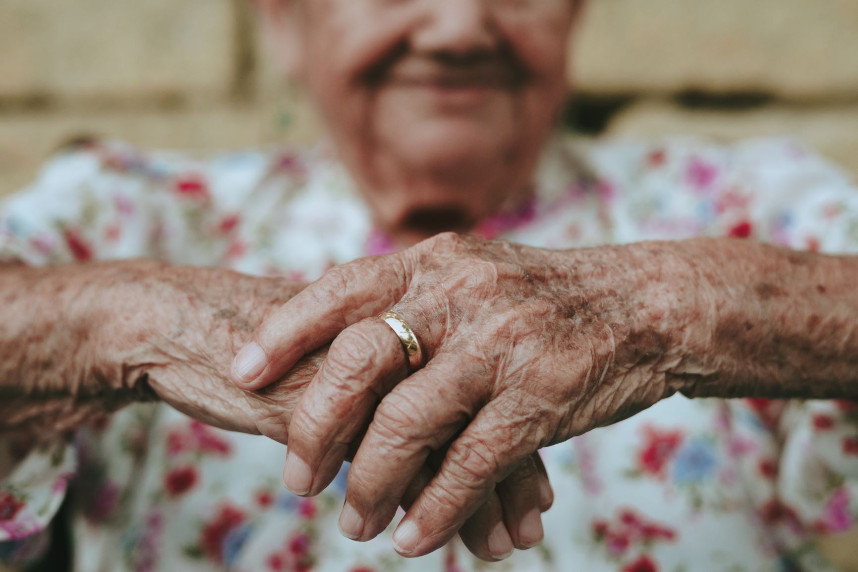 older adult with hands focused