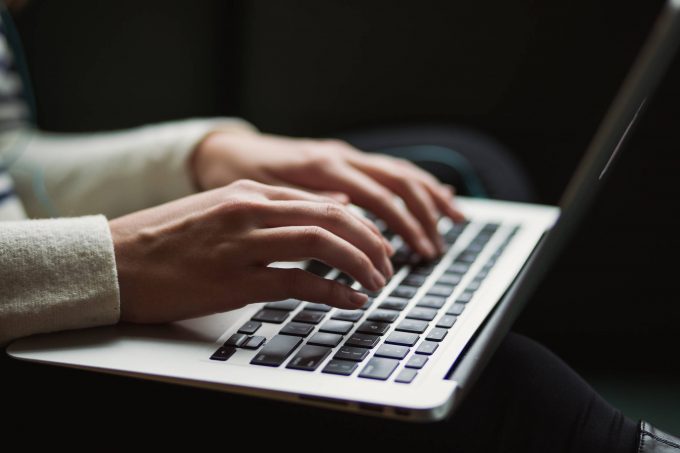 someone typing on a laptop