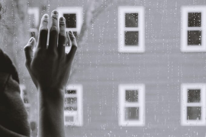 hand on rainy window