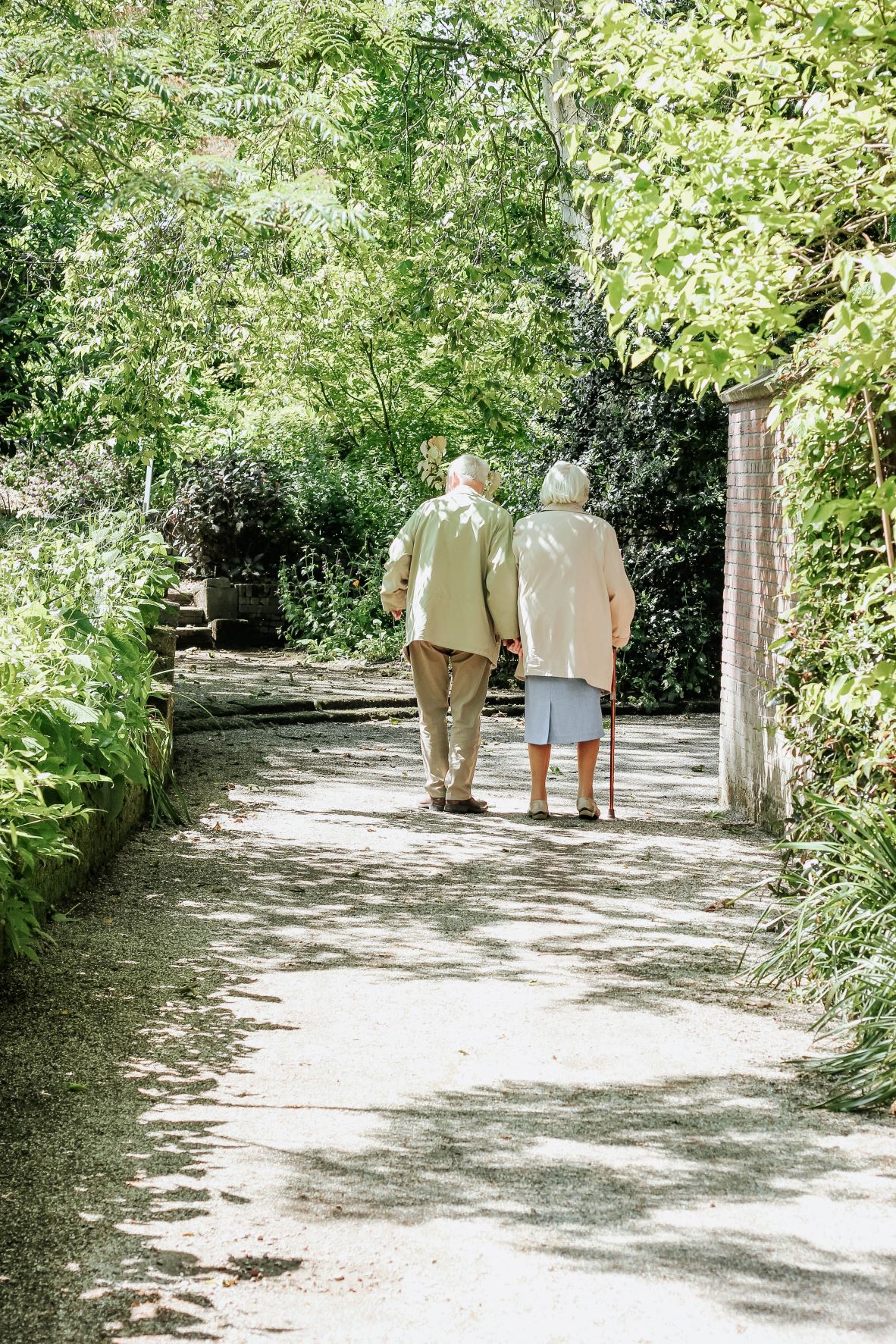 two older couples standing with trees surrounding them